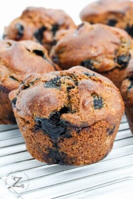 Sourdough Blueberry Muffin on a metal rack with muffins behind
