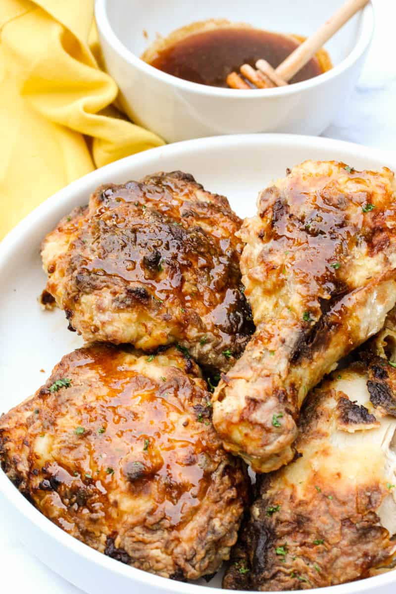 Air Fryer Buttermilk Fried Chicken in a bowl with sauce in the background