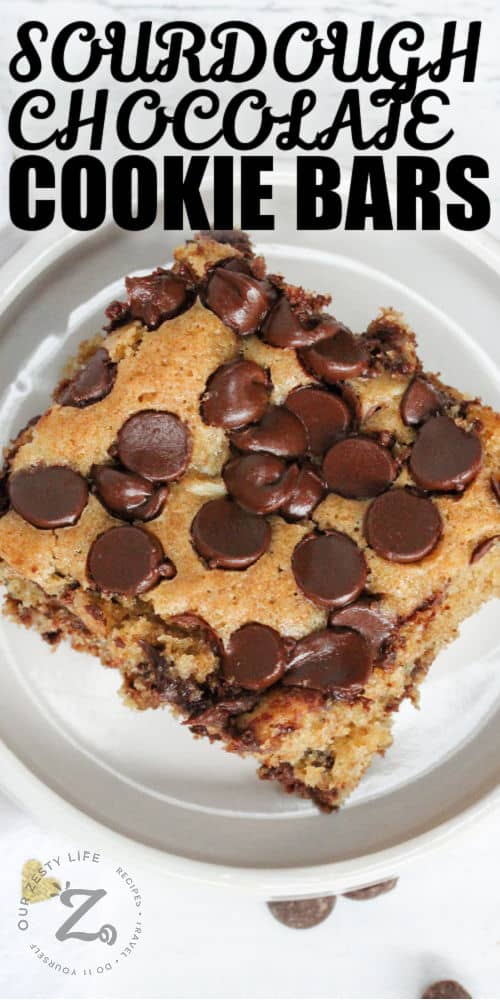 Sourdough Chocolate Chip Cookie Bars on a plate with writing