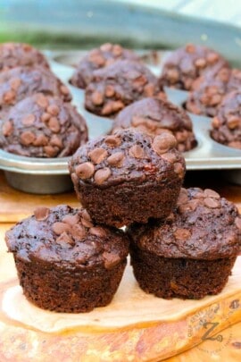 Chocolate Zucchini Muffins with muffin tray in the background