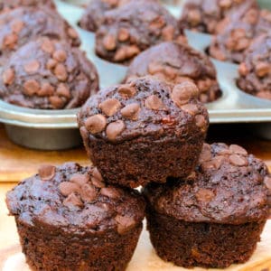 Chocolate Zucchini Muffins with muffin tray in the background