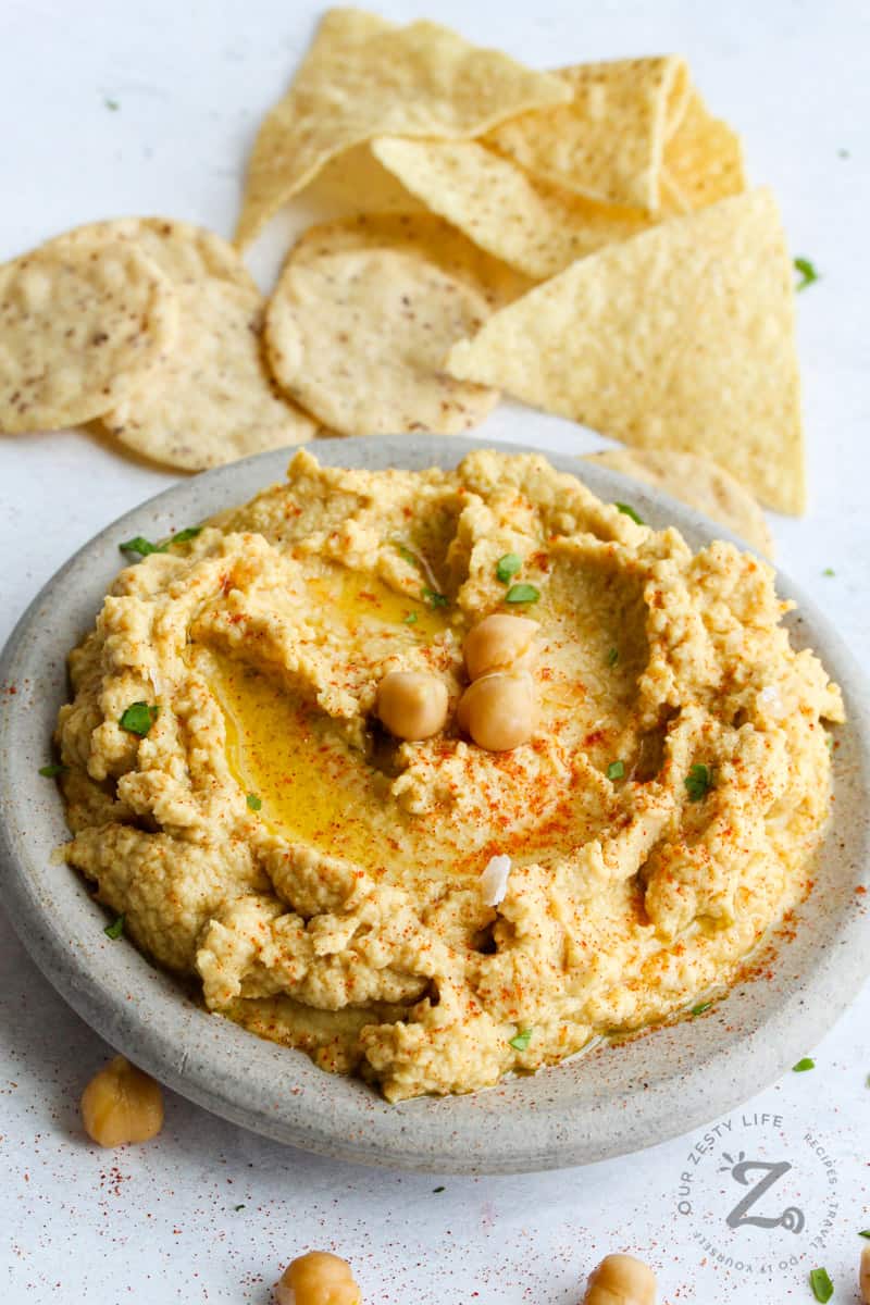 Hummus on a marbled platter with chips