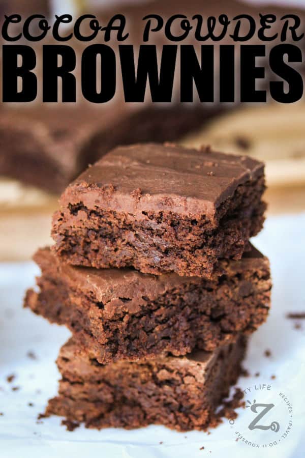 Cocoa Powder Brownies stacked on top of eachother with writing