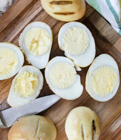Smoked Eggs on a cutting board with sliced and whole eggs