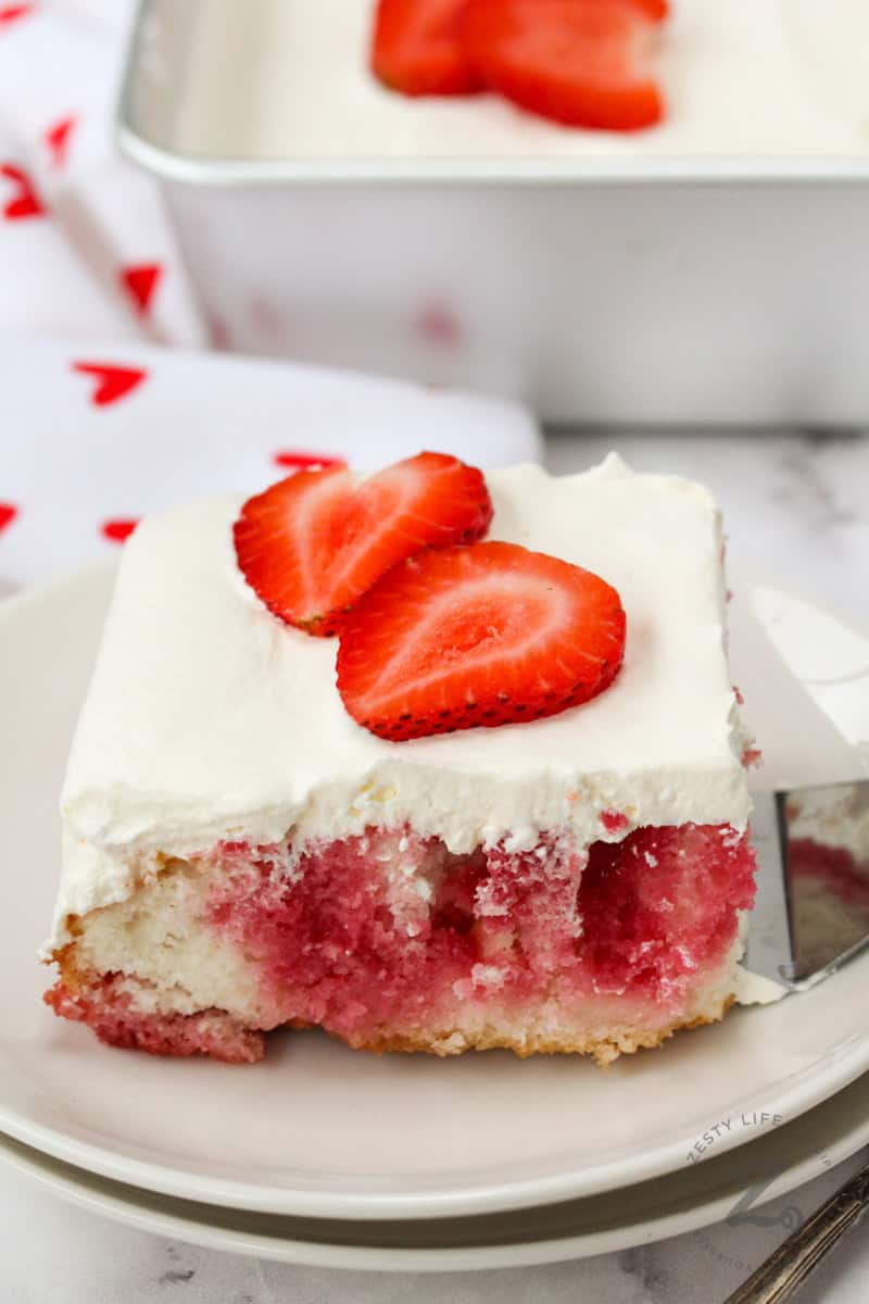 piece of Strawberry Poke Cake on a plate