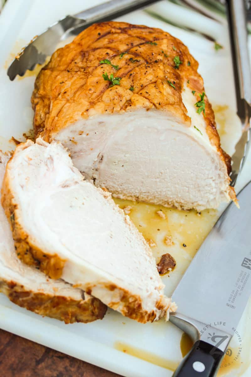 slices of pork with a knife to show how to make Roast Pork with Pears