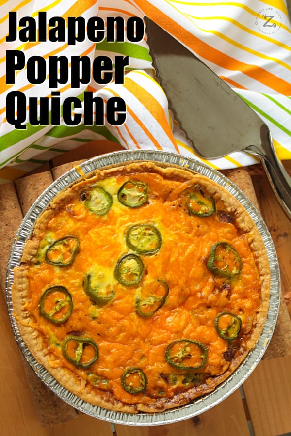 overhead of a whole Jalapeno Popper Quiche in a pie tin with a pie slicer on the side