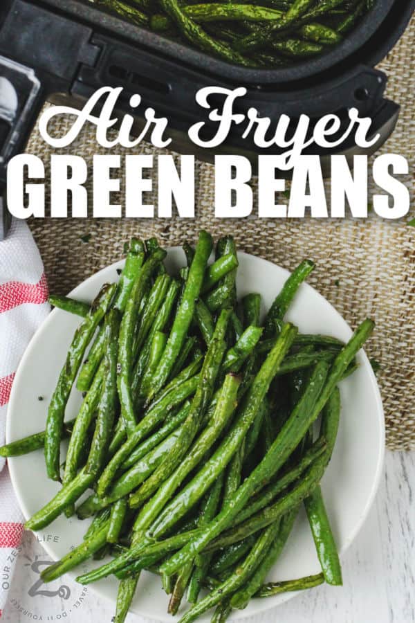 Air Fryer Green Beans on a plate with writing and an air fryer in the background