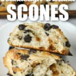 close up of Chocolate Chip Sourdough Scones in half on a plate with writing