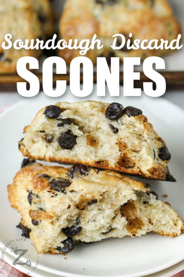 close up of Chocolate Chip Sourdough Scones in half on a plate with writing
