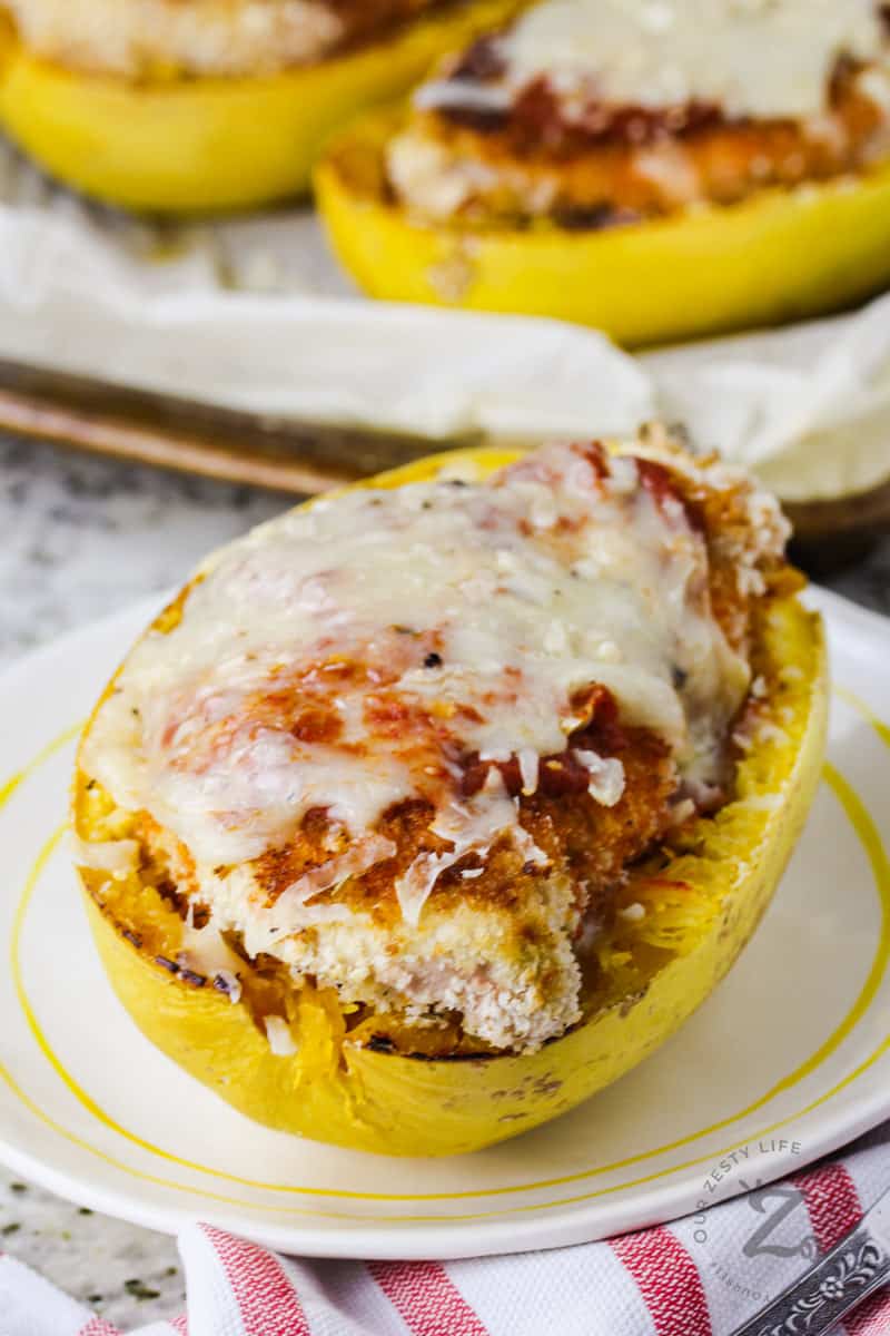 plated Spaghetti Squash Chicken Parmesan with baking sheet full in the background