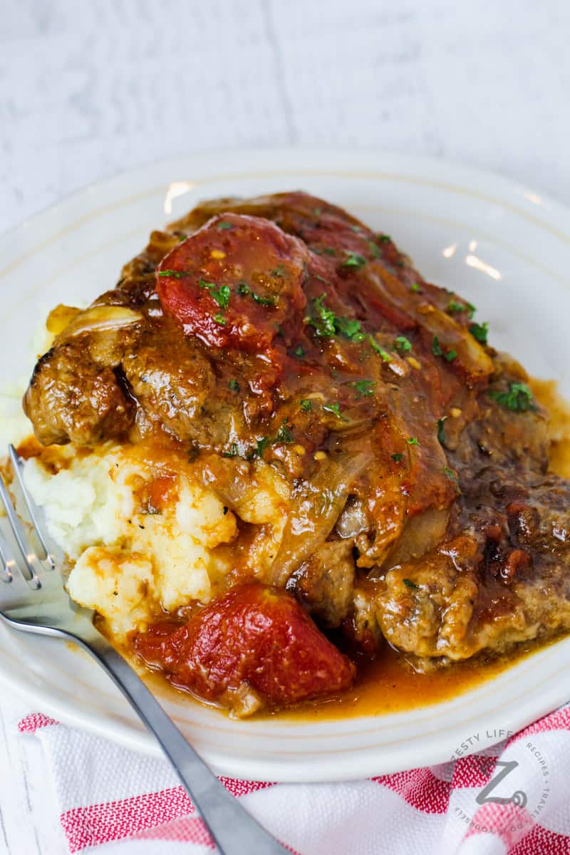 plated Swiss Steak with a fork