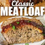 slices of Homemade Meatloaf on a plate with writing