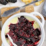 Baked Brie with Berries in a bowl with berries and crackers around it