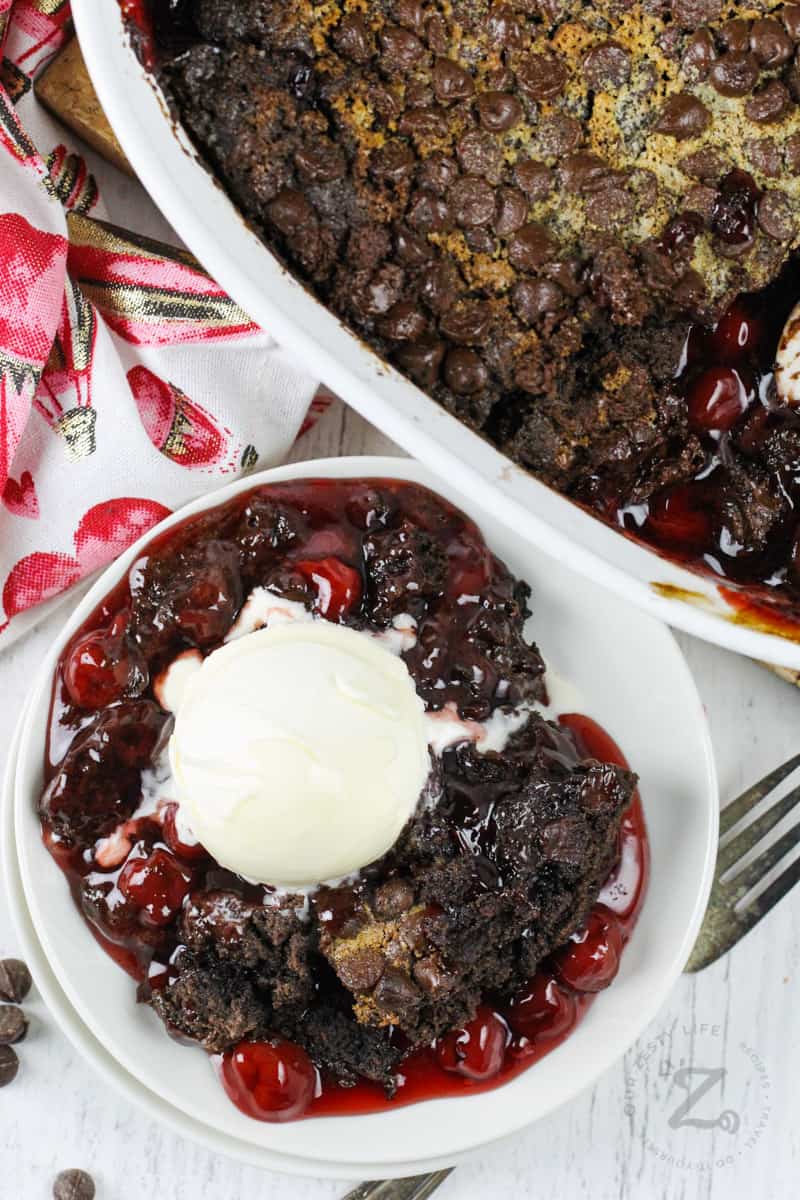 top view of Chocolate Cherry Dump Cake and a plated slice with ice cream