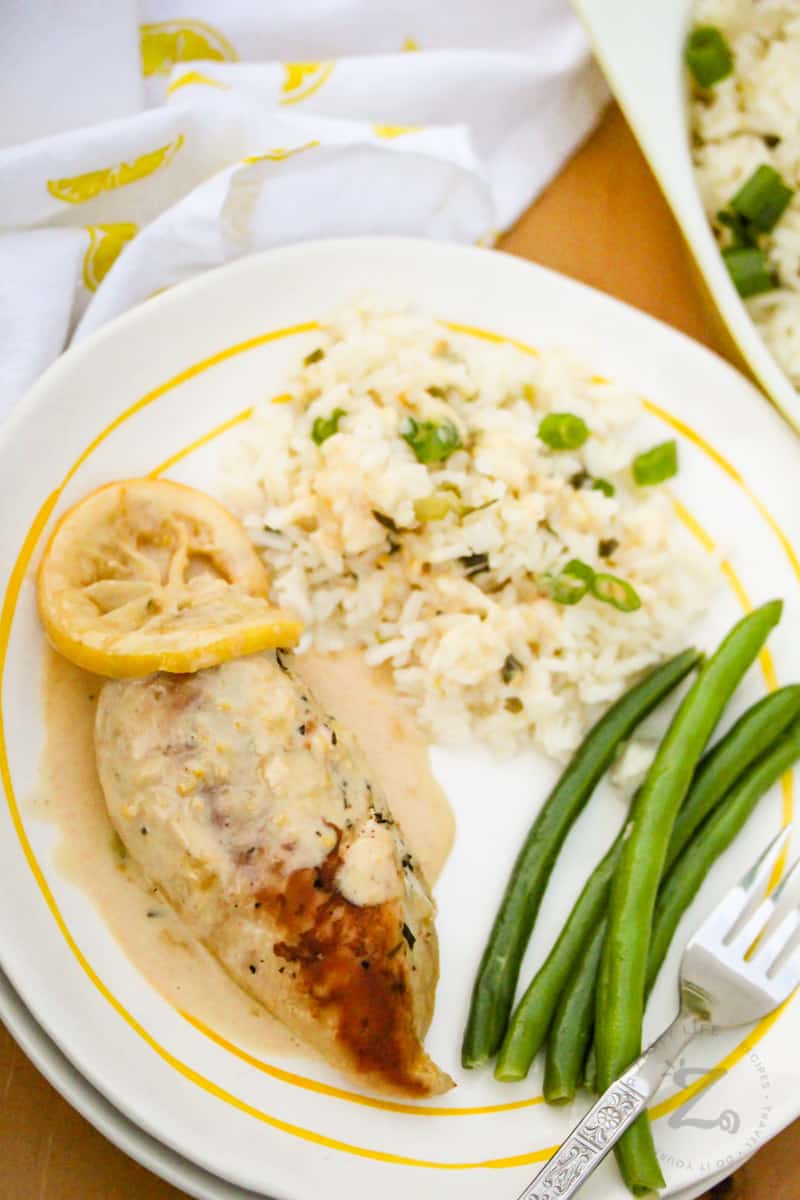 plated Creamy Lemon Chicken with beans, rice and a fork