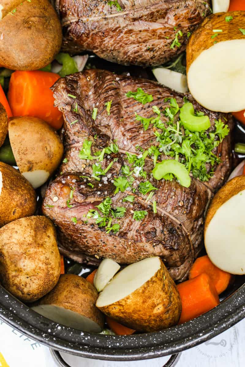 top view of Pot Roast , carrots and potatoes in pan