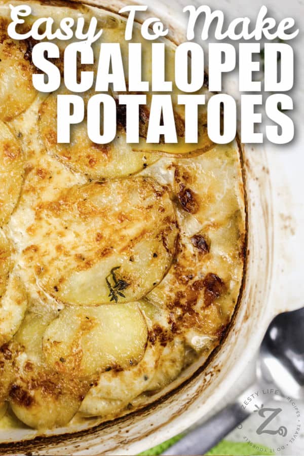 top view of Cheesy Scalloped Potatoes in a dish with writing