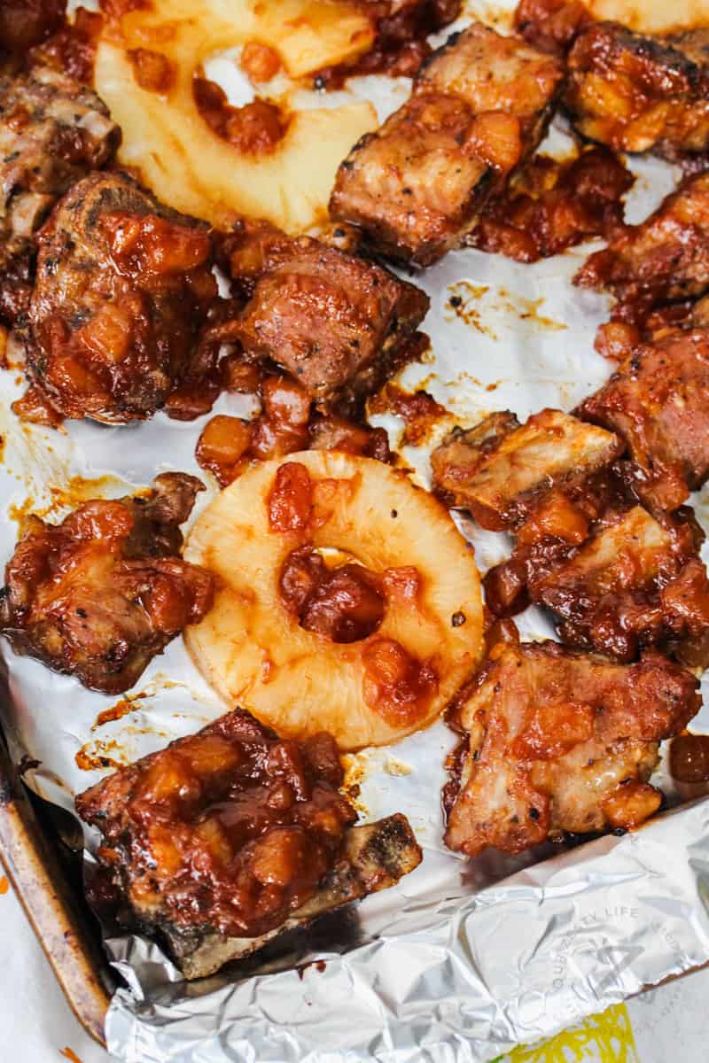 Sweet and Sour Spare Ribs with pineapple on a baking sheet