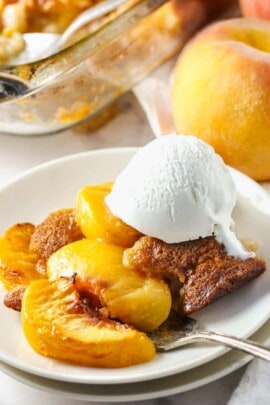 plated Peach Cobbler with the casserole dish in the back