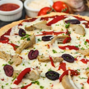 close up of ingredients on top of a Greek Pizza