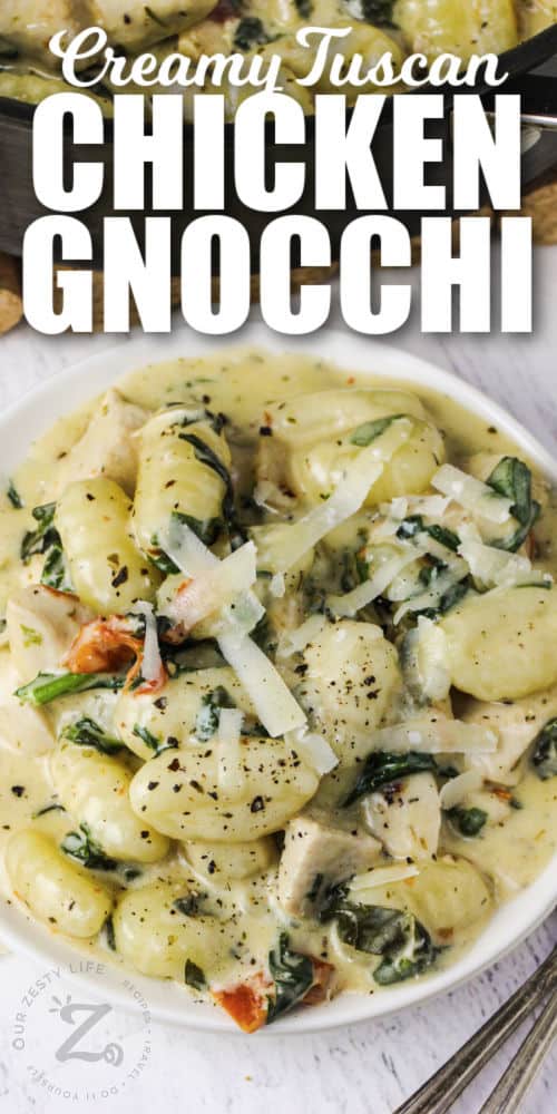 plate of Creamy Tuscan Chicken Gnocchi with cheese and a title