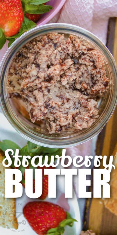 top view of Strawberry Butter in a jar with strawberries and writing
