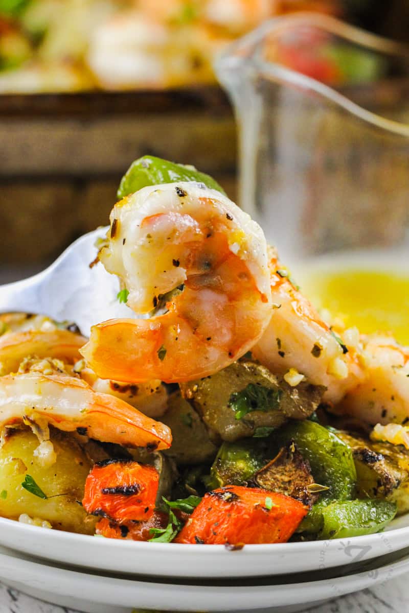 Shrimp Sheet Pan Dinner on a plate with a fork full