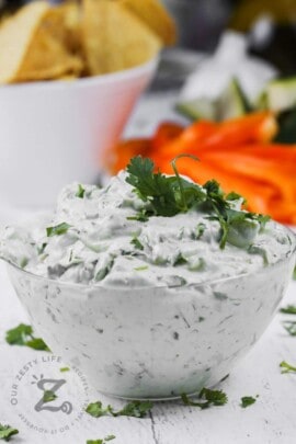 bowl of Easy Greek Yogurt Dip with chips and peppers in the back
