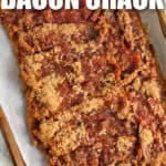 Baked Bacon Crack on a parchment lined baking sheet with writing