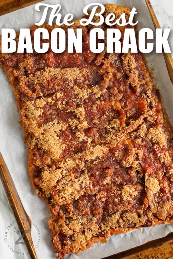 Baked Bacon Crack on a parchment lined baking sheet with writing