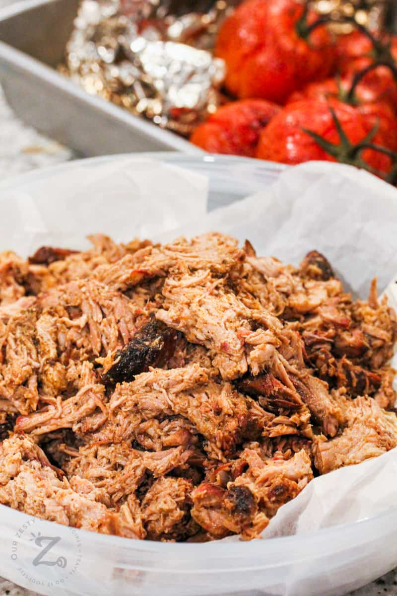 Smoked Boston Butt Recipe shredded with tomatoes in the back