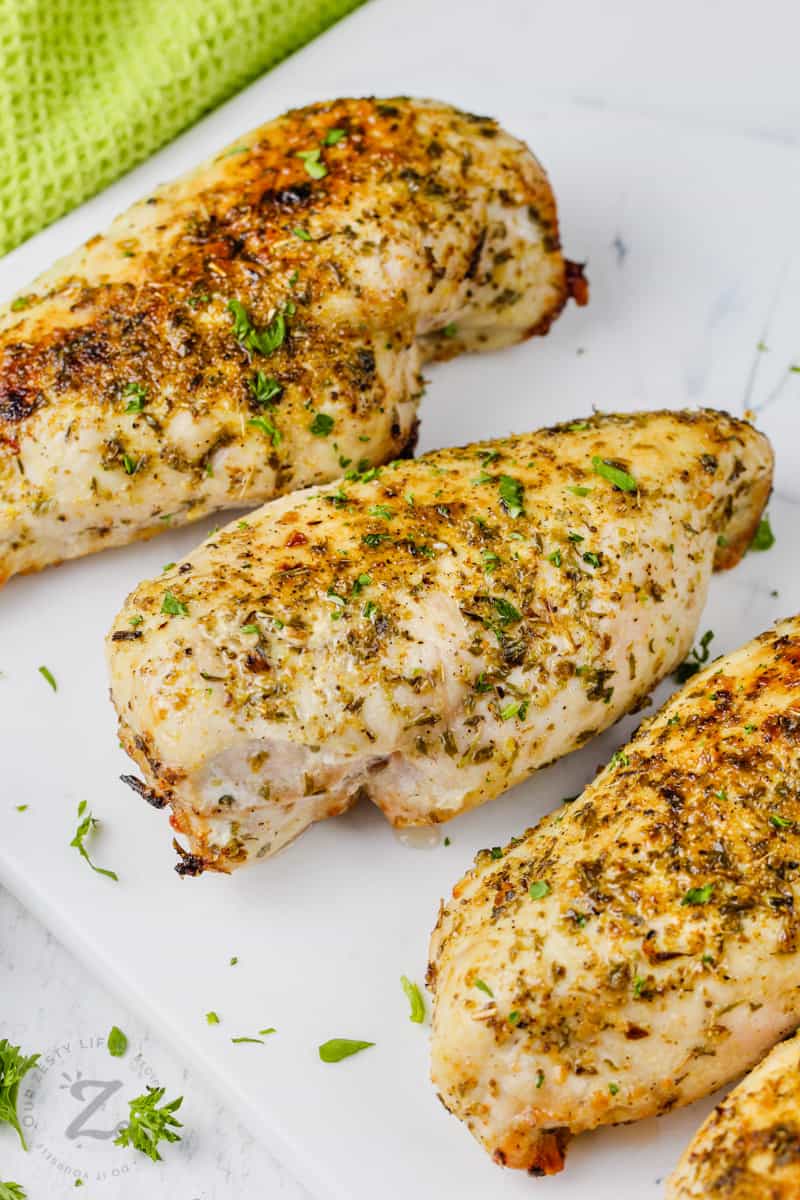 cooked Air Fryer Chicken Breasts on a cutting board