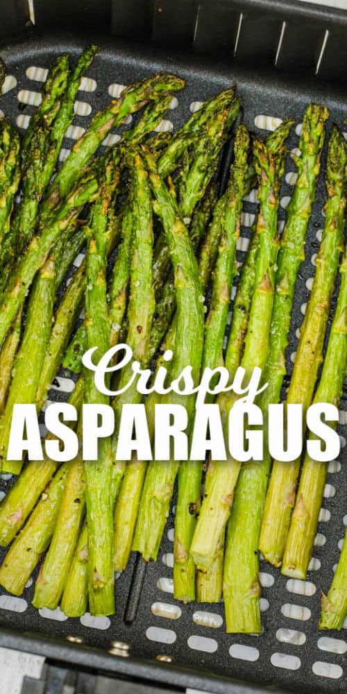 cooked Air Fryer Asparagus in the air fryer with writing