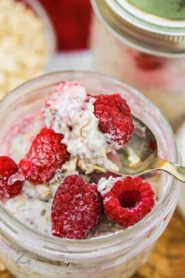 close up of Overnight Oats with Fruit and raspberries on top