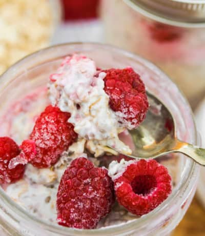 close up of Overnight Oats with Fruit and raspberries on top