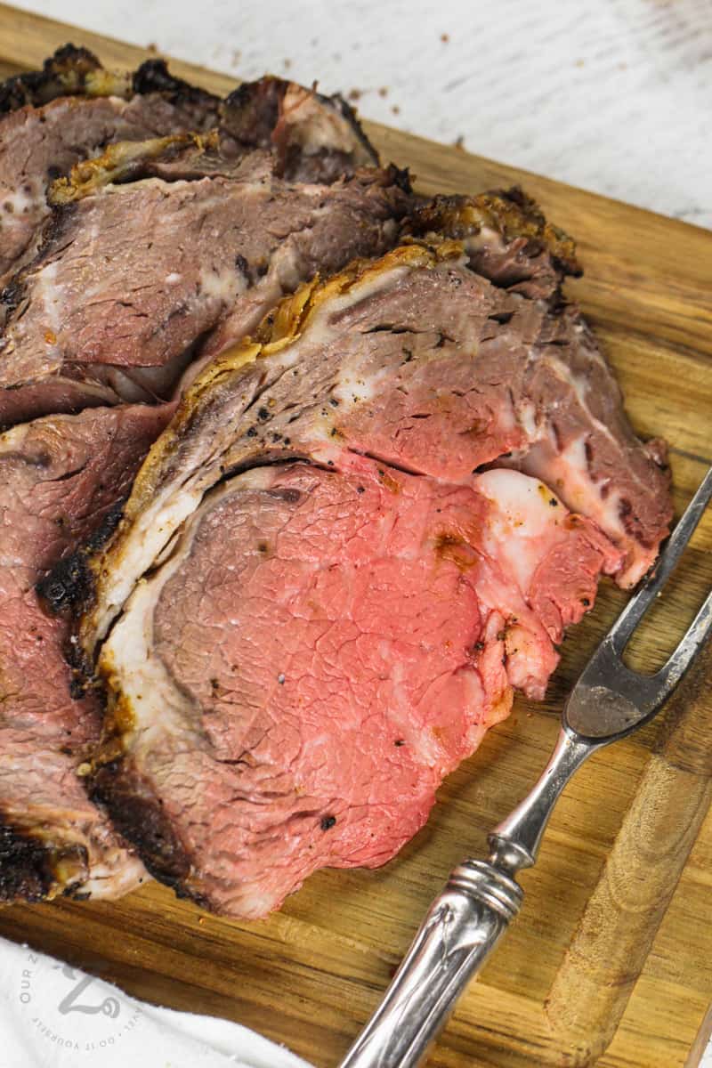 close up of Reverse Sear Prime Rib with a fork on a cutting board