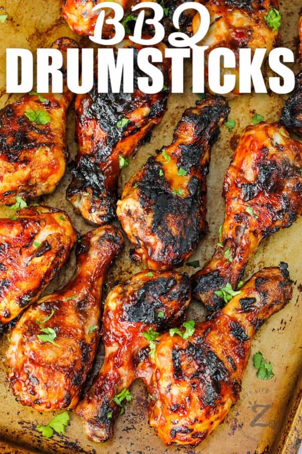 BBQ Drumsticks cooked on a baking sheet with a title