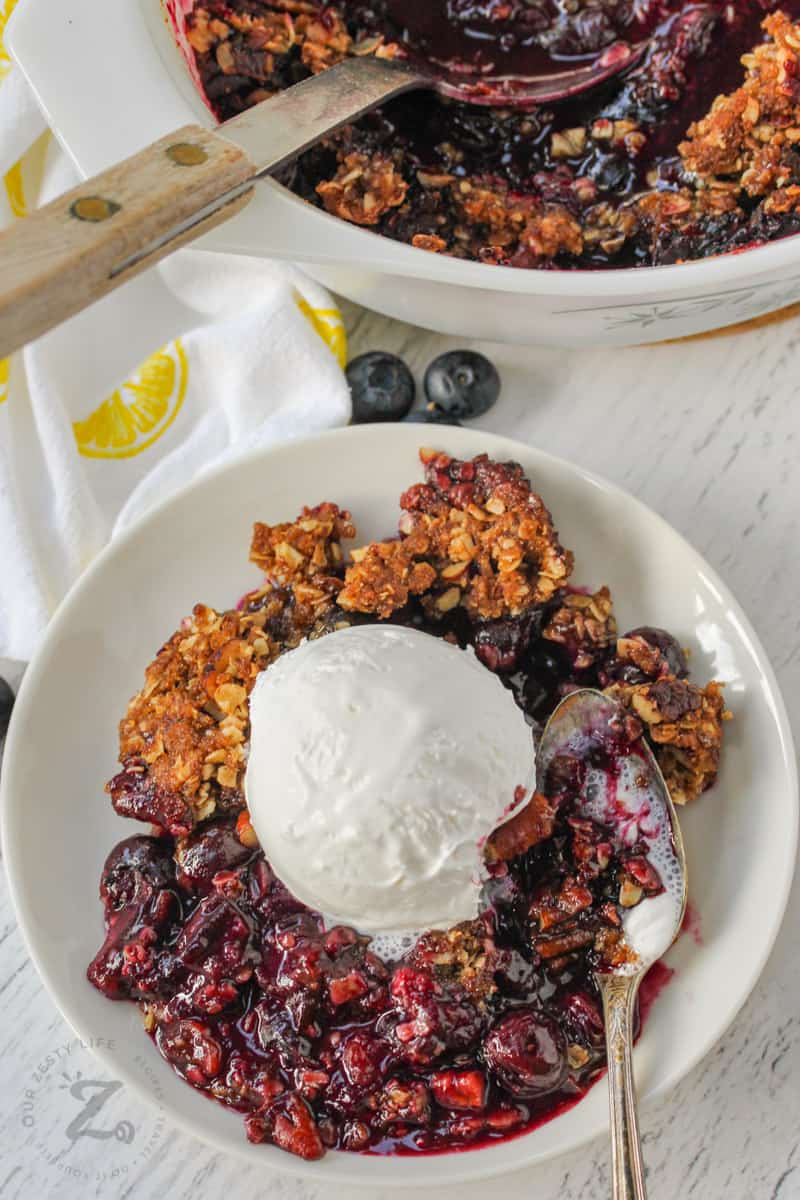 Blueberry Crisp with ice cream and a spoon