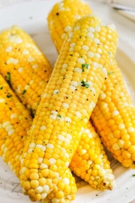 close up of Grilled Corn in Foil on a plate