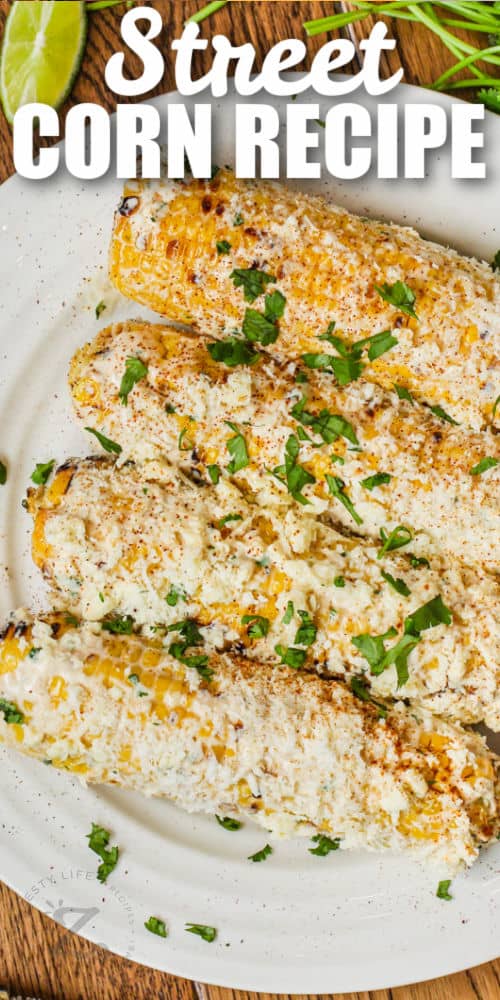 Mexican Street Corn with cilantro on a plate with a title