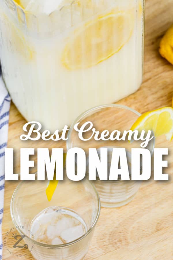 Creamy Lemonade in a jug with glasses with lemon and writing