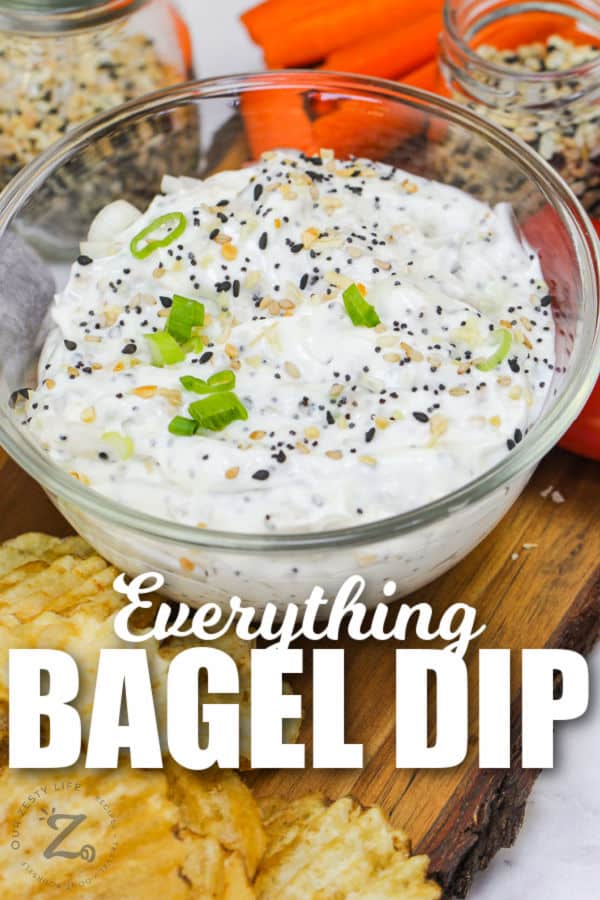 Everything Bagel Dip in a glass bowl with writing