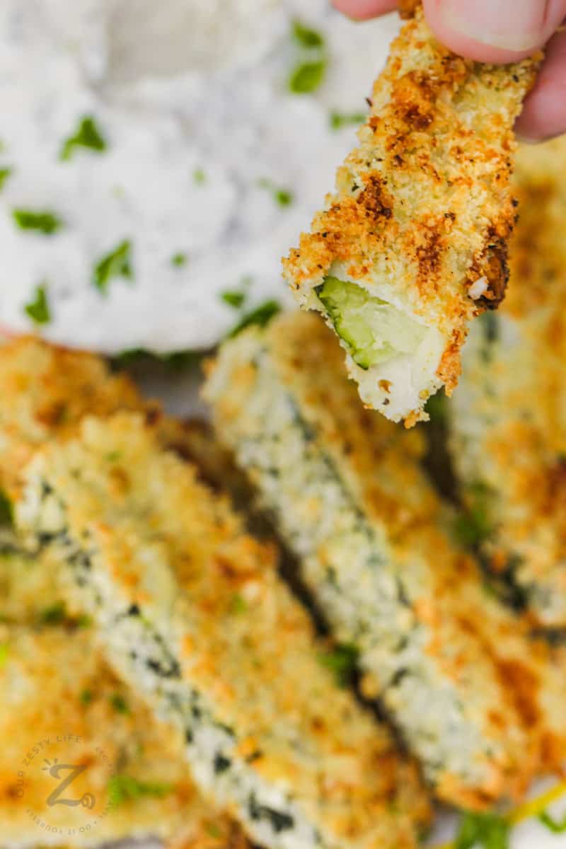 Baked Zucchini Sticks with a bite taken out of one
