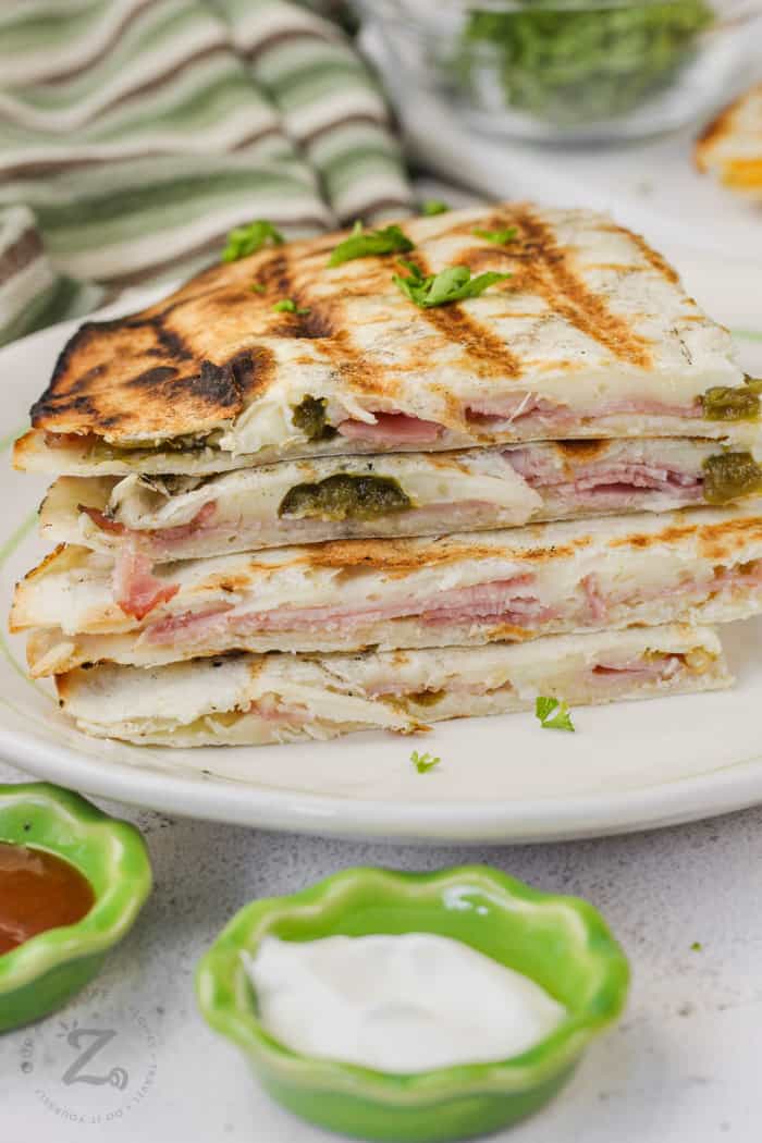 close up of ham and cheese quesadillas with jalapeños hot off the grill