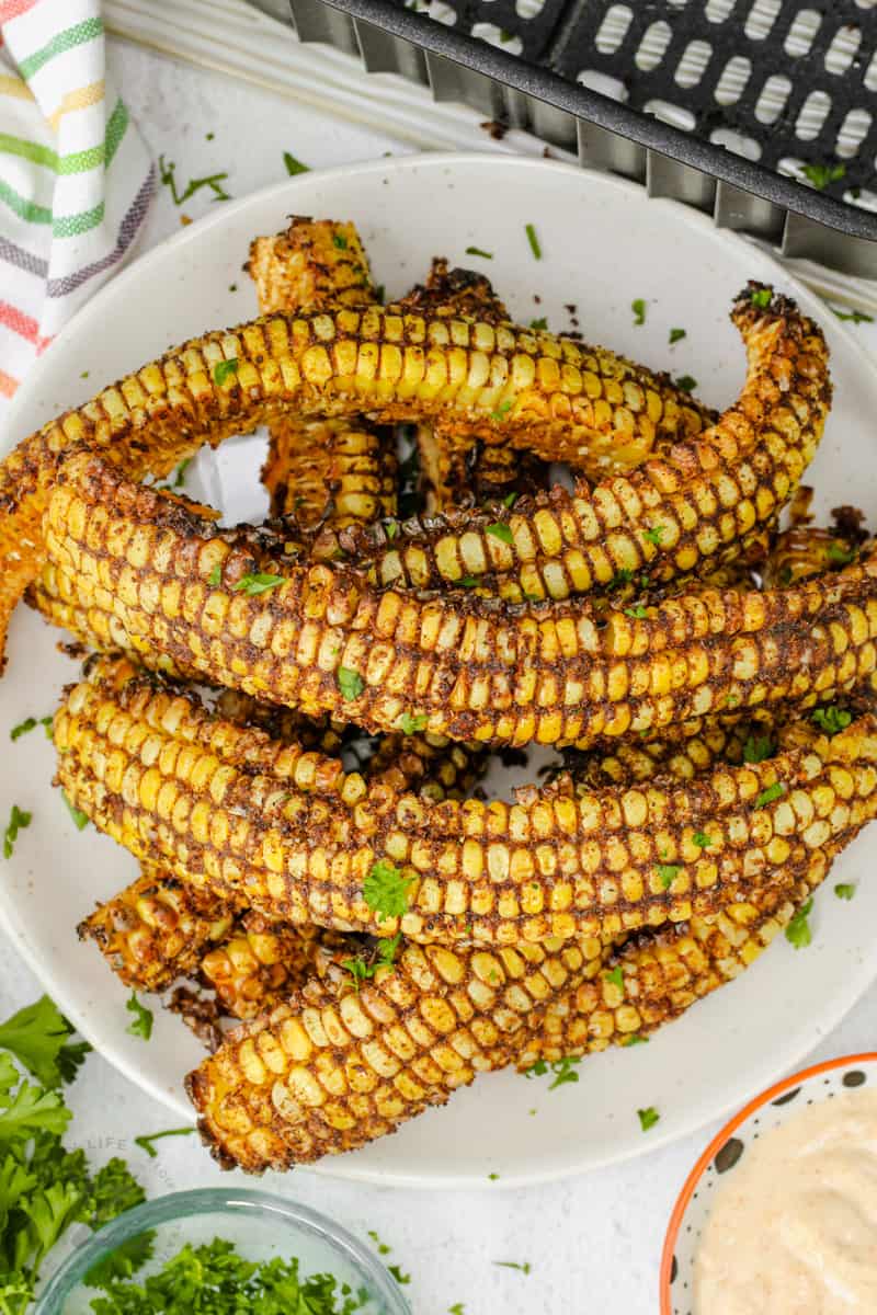 top view of Air Fryer Corn Ribs on a plate with garnish