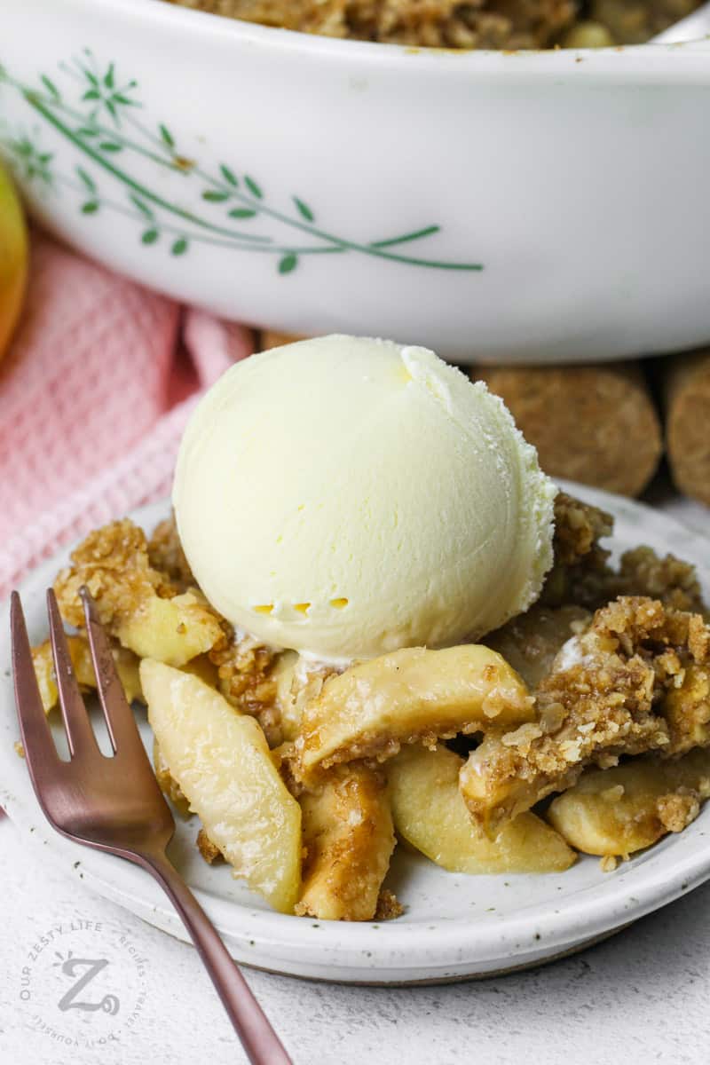 plated Apple Crisp Recipe with ice cream and a fork