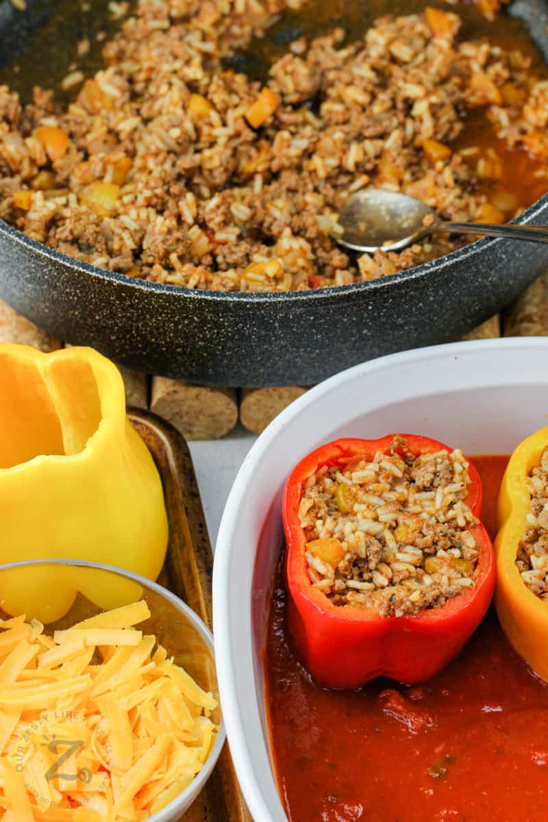 adding stuffing to peppers to make Easy Stuffed Peppers