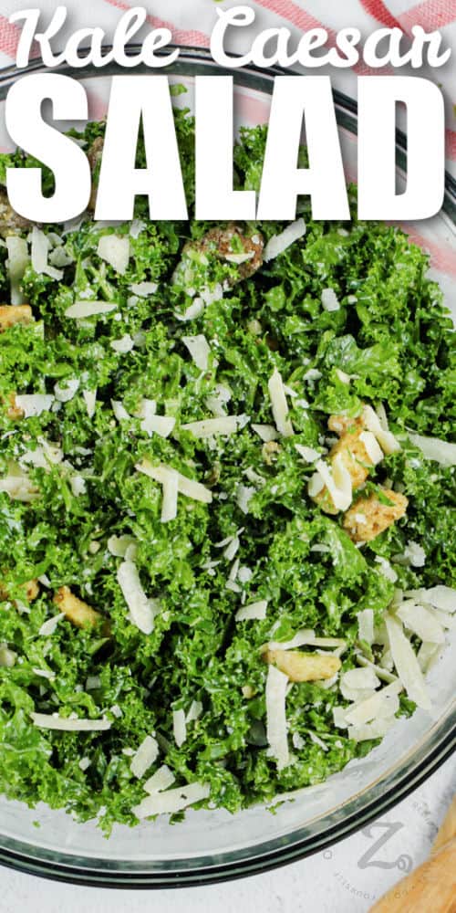 mixed Kale Caesar Salad in a glass bowl with a title