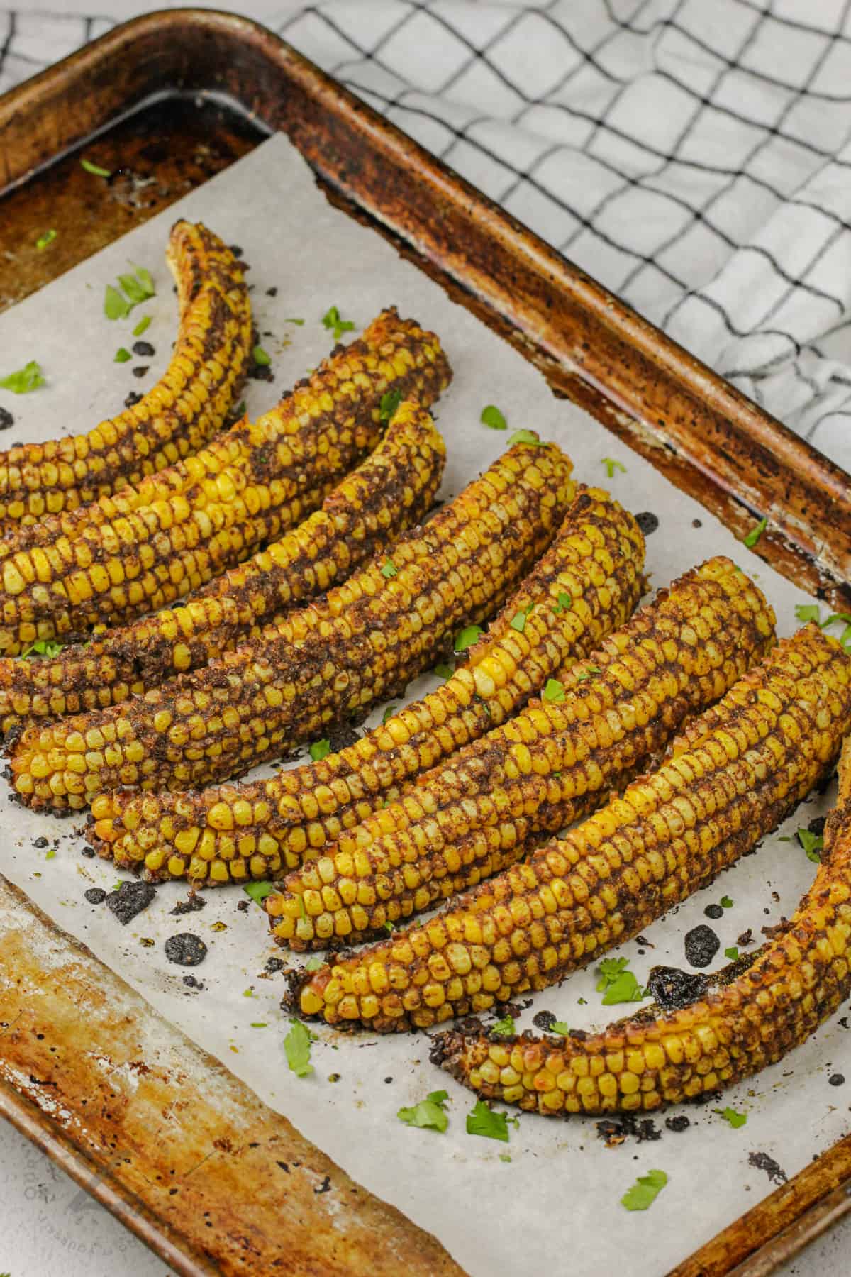 Baked Corn Ribs with seasonings on top of a baking sheet